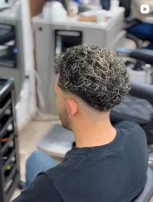 Textured curly men’s haircut at the Elegance barbershop