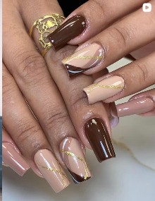 Gel nails with gold detailing at Elegance Salon & Spa